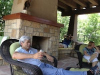 a man is sitting in a wicker chair