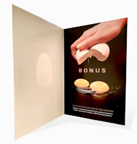 a person is holding an egg in an open book