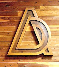 a wooden sign with the letter d on it