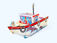 a toy boat with a picture of a dolphin on it