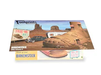 a box with a pair of sand shoes in it