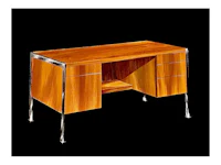 a wooden desk with chrome legs and drawers