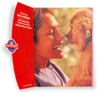 a woman is holding a dog and smiling at it